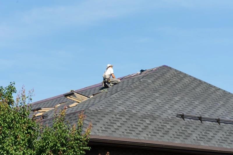 Worker replacing roof