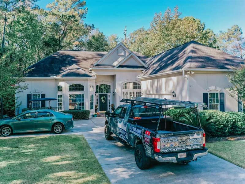 Roofing truck parked in driveway during new roof installation