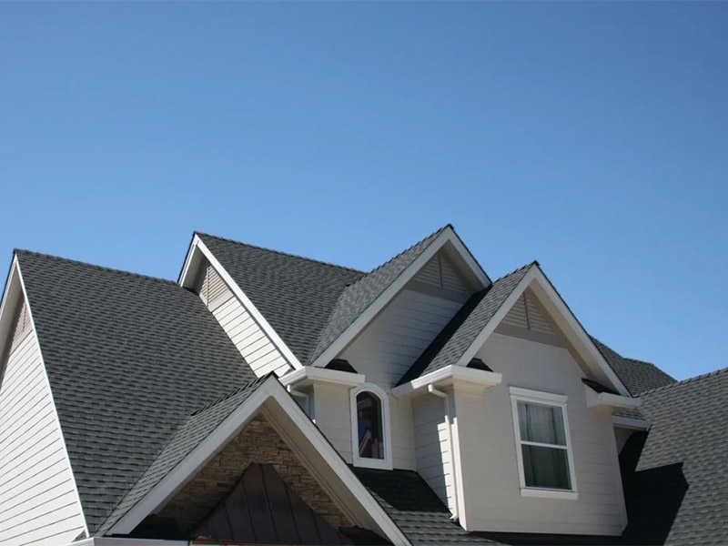 New asphalt shingle roof on a white house