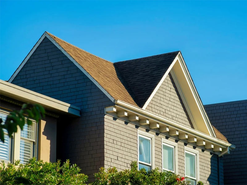 Double gable roof with asphalt shingles.