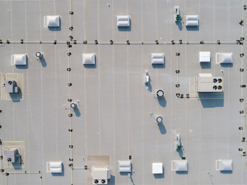 Aerial view of a commercial building with flat roofing.