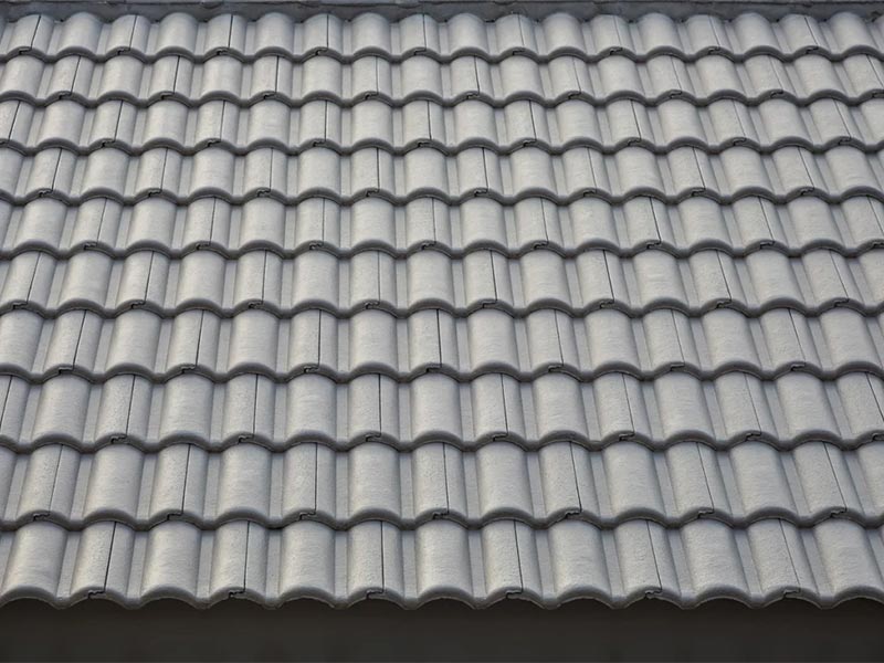 Close-up view of a gray concrete tile roof.