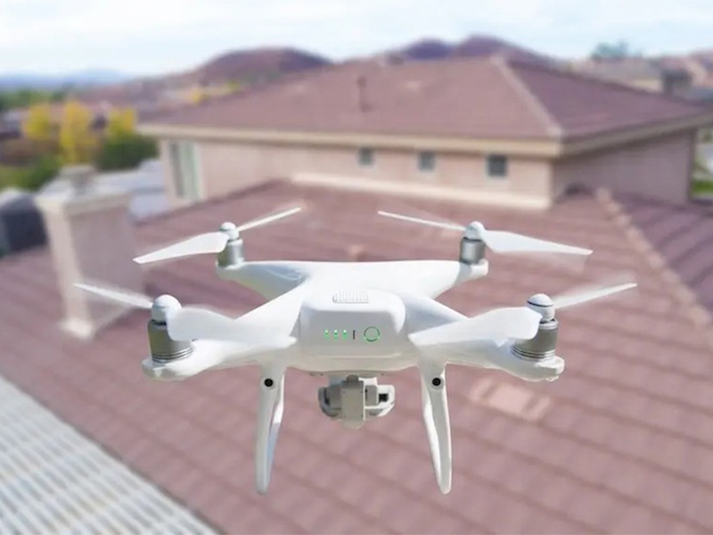 Drone flying over a home for roof inspection