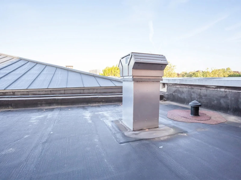 Flat commercial roof with installed vent and EPDM membrane.
