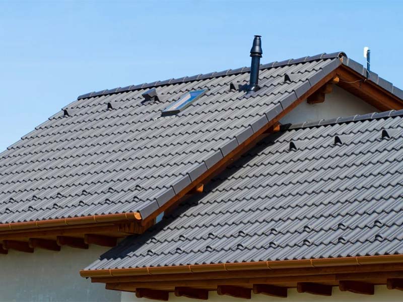 Concrete tile roof with skylight and vent