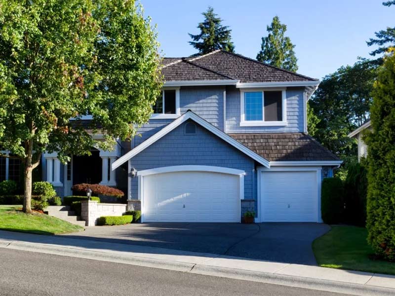 House with wood shake roofing and dormer windows
