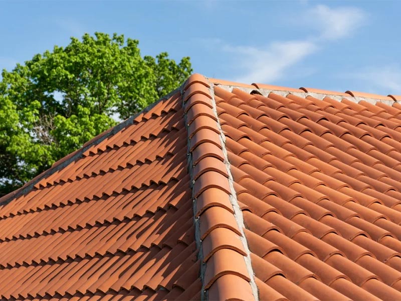 Tile roof replacement in progress on a home