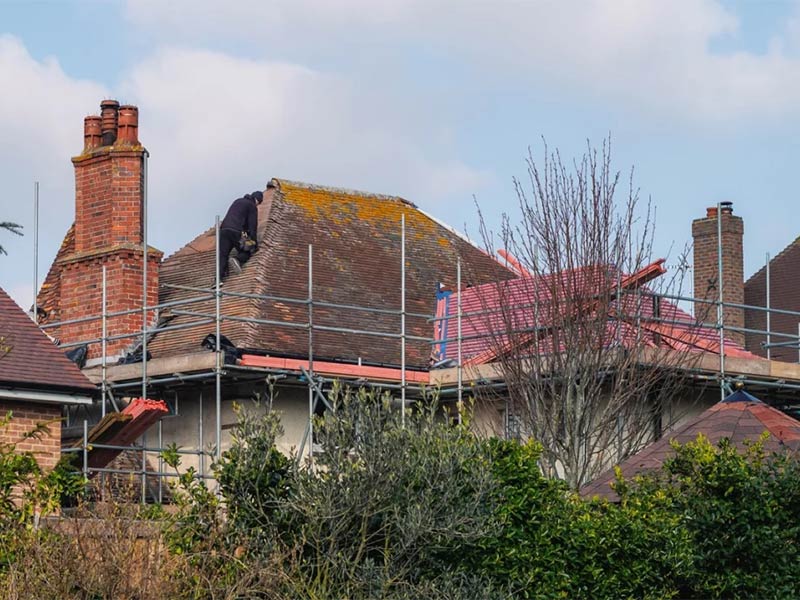 Old house roof being replaced with scaffolding.