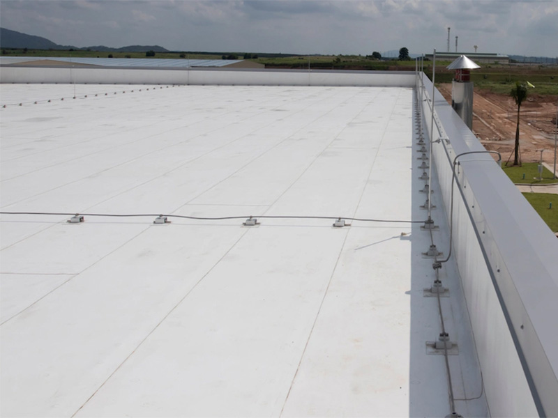 White PVC flat roof with safety anchor lines.