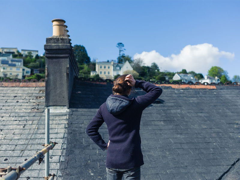 Homeowner looking at a roof for inspection.