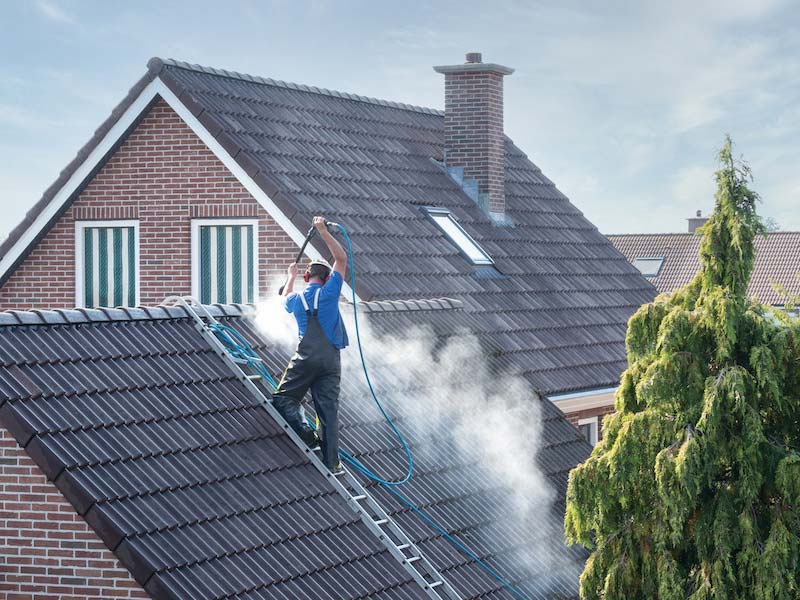 Roof cleaning and maintenance in progress.