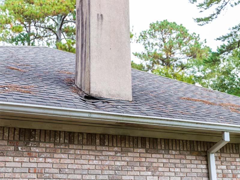Roof damage around chimney and shingles