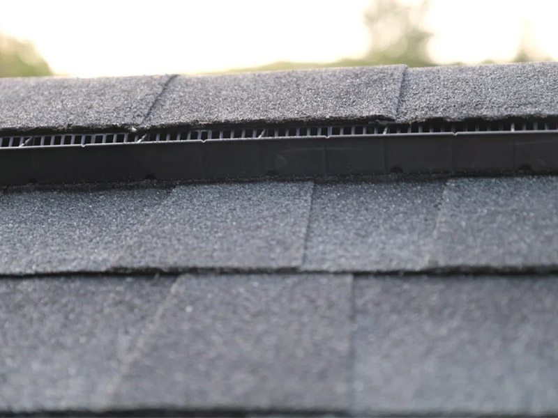 Roof ridge cap and vent installation close-up