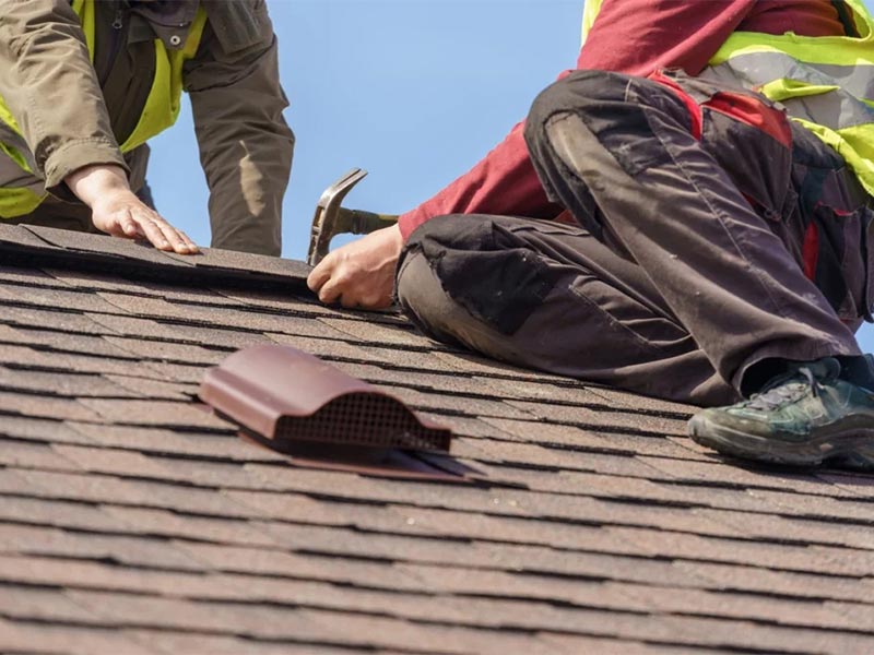 Roofer installing a new asphalt shingle.