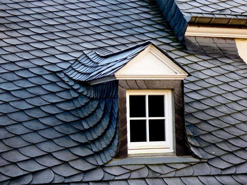 Slate roof with a small dormer window.