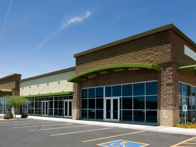 Modern small business building with large glass windows.