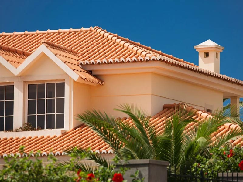 House with a red tiled roof and dormer windows.