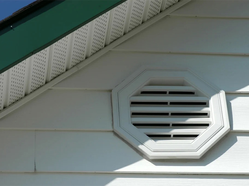 White soffit air vent on a house exterior.