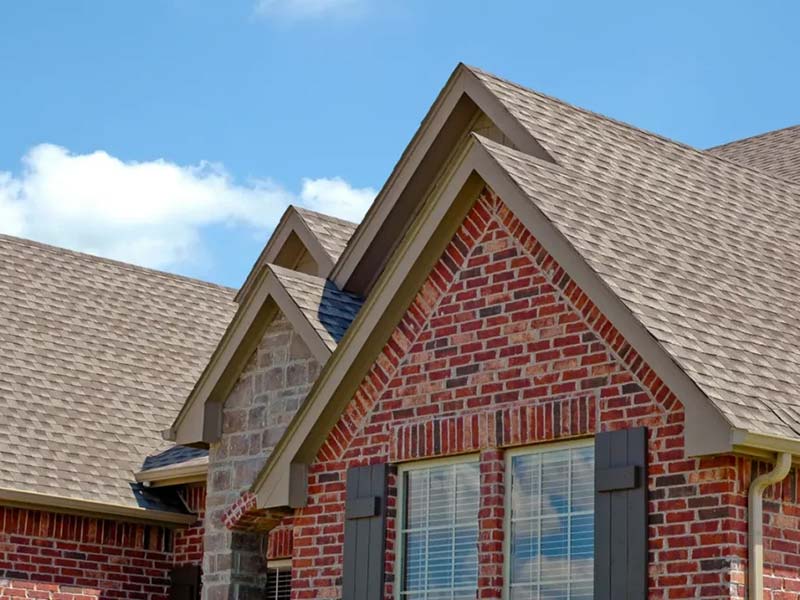 brick house with architectural shingles
