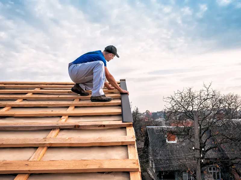 A man walking on roof frame